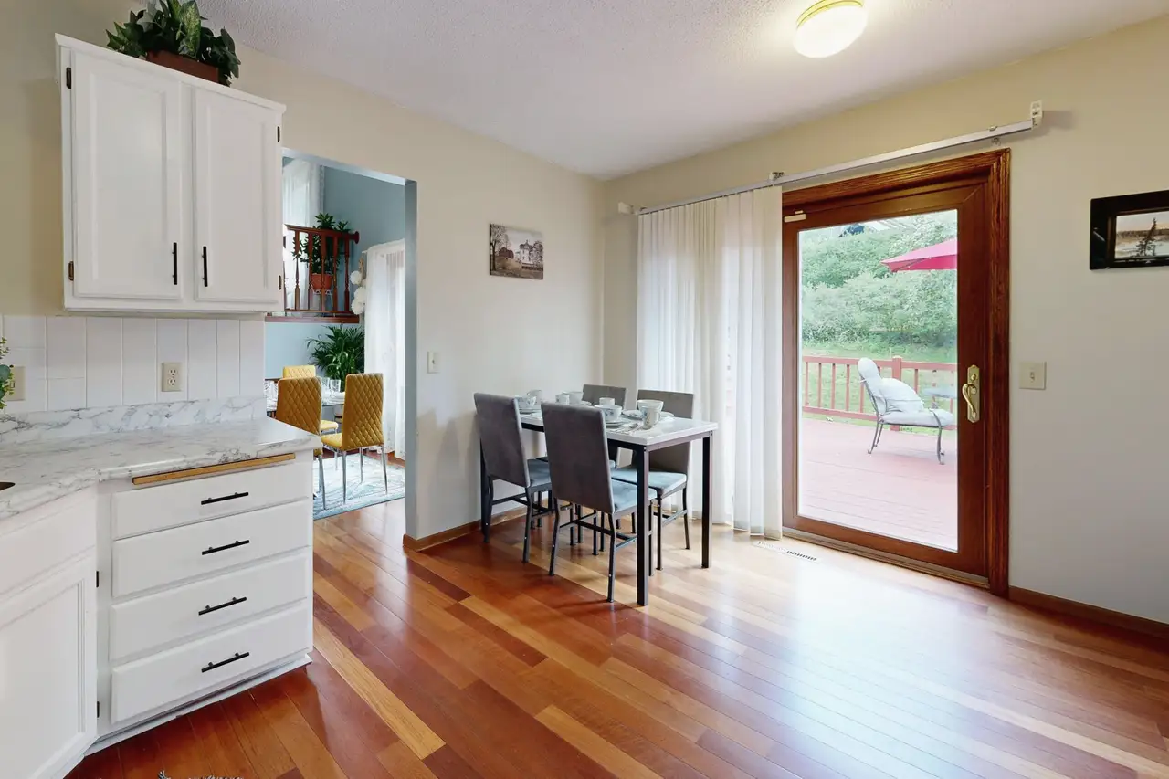 Kitchen and dining area with a glass door to a deck