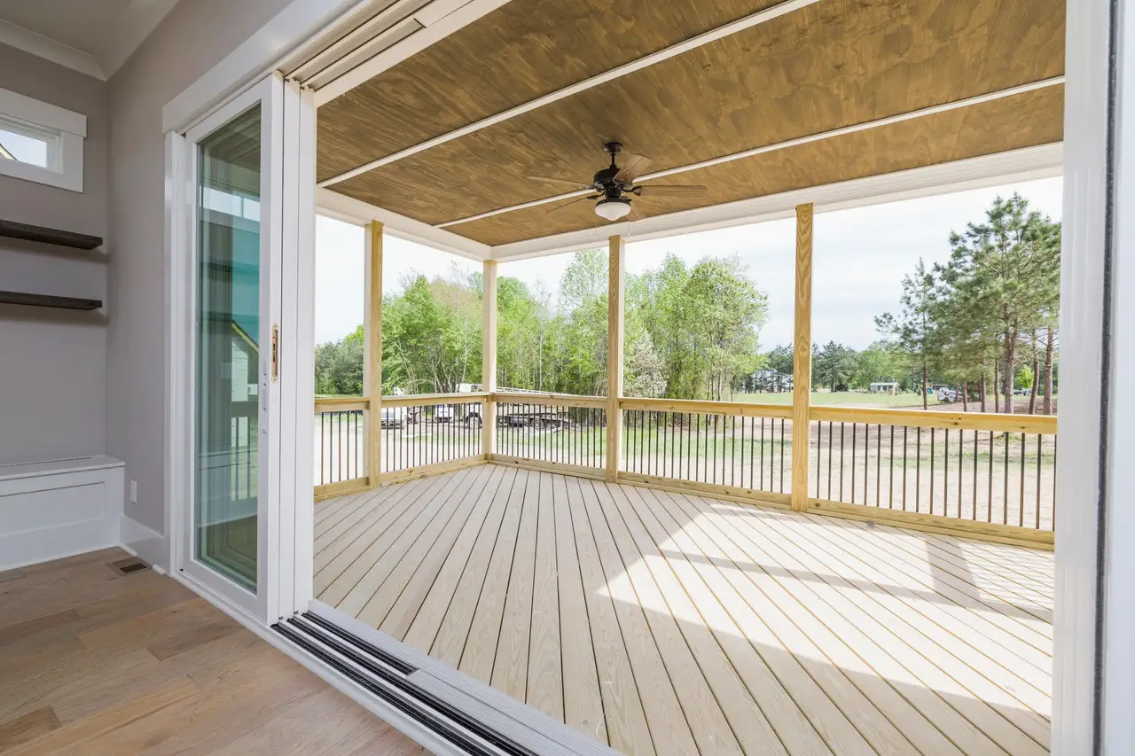 Wide sliding glass doors opening onto a covered porch